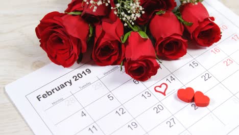 Bouquet-of-red-roses-on-the-calendar-showing-14th-February-4k