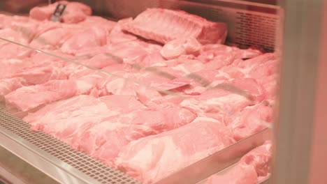 a meat shop specializing in fresh products. the scene shows neatly arranged meat on display counters, showcasing high-quality cuts in a clean and professional retail environment