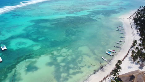 Aerial-view-of-the-clear-water-beach-in-Akumal-in-the-mayan-riviera-with-yachts-and-catamarans-in-the-Mayan-Riviera,-Mexico