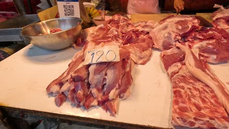 sequential meat cutting and preparation on butcher's table.