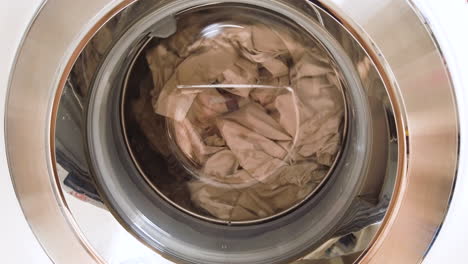 close-up on a washing machine with clothes