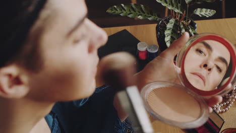 Young Transgender Man Applying Powder to Face