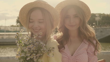 two friends in straw hats and dresses