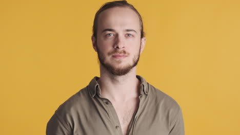 Caucasian young man looking serious at the camera.