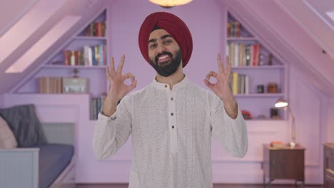 happy sikh indian man showing okay sign