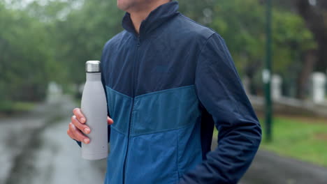 man drinking water in the rain