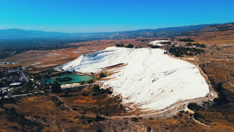 Aerial-4K-drone-video-of-a-tourist-attraction-Pamukkale,-natural-pool-with-blue-water,-Turkey-Calcareous-minerals