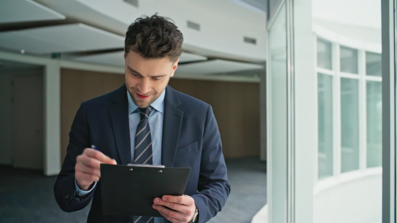 Happy employee walking corridor with clipboard greeting colleagues closeup