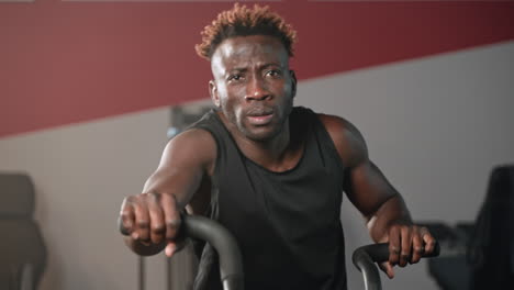 man working out on a stationary bike in a gym