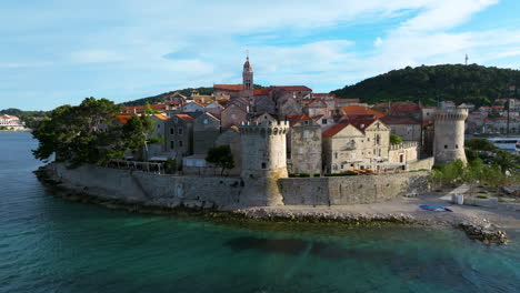 adriatic sea, korcula old town, tower and beach in croatia. - aerial shot