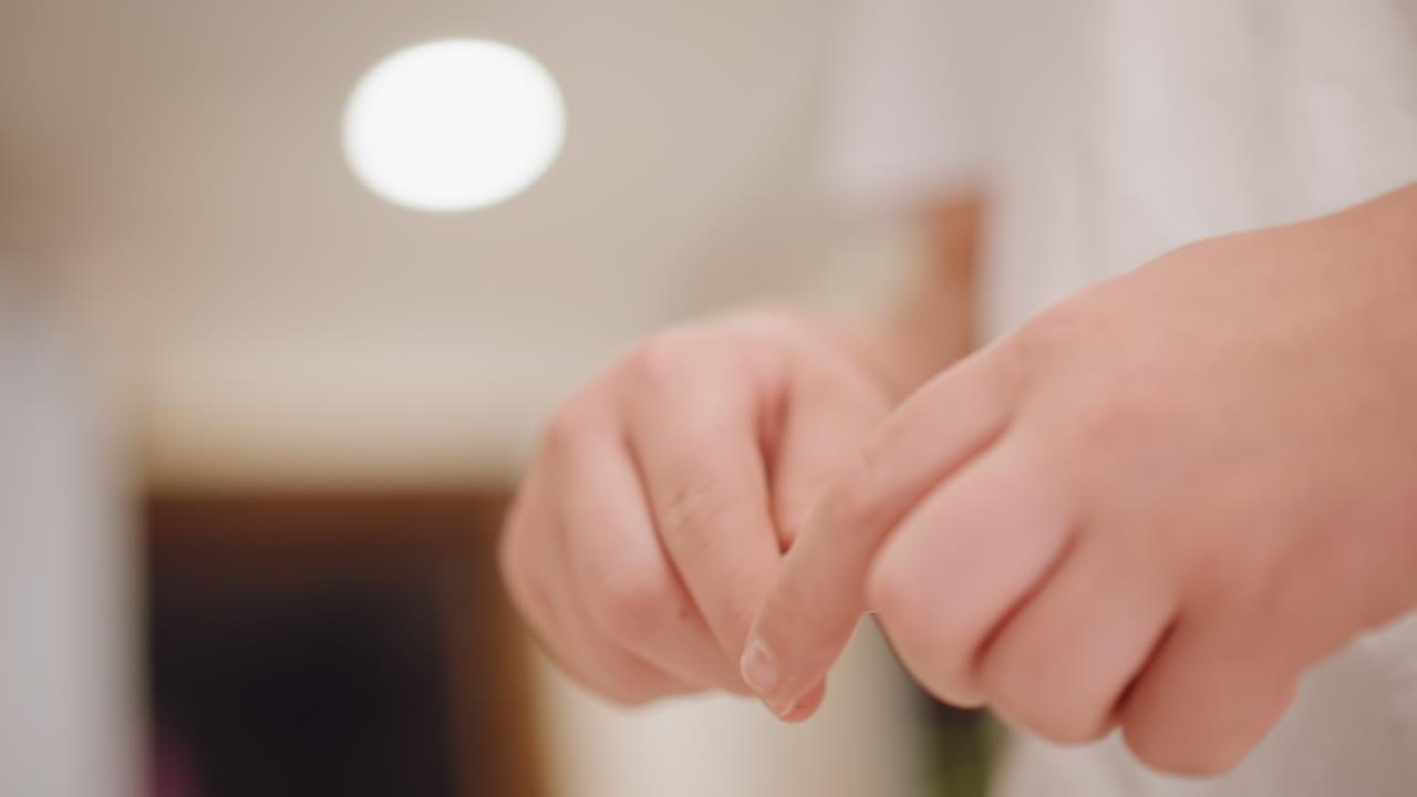 Tight caucasian hands uncapping marker pumpkin pie, red tip revealed, flourspeckled fingers, overhead light bokeh, efficient small bakery packaging scene with precise labeling gesture