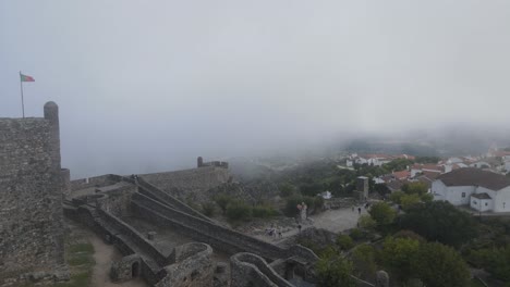 A-drone-flies-through-the-mist-over-an-ancient-castle