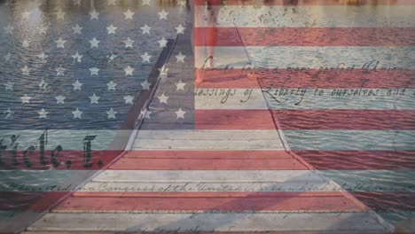 Constitution-text-and-american-flag-against-low-section-of-caucasian-woman-walking-on-wooden-pier