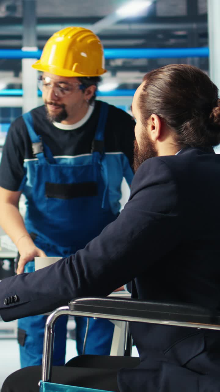 Vertical Video Solar Panels Plant Supervisor With Paraplegia In Wheelchair Talks With Employee