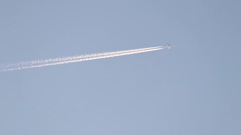 airplane flies out of frame on clear day