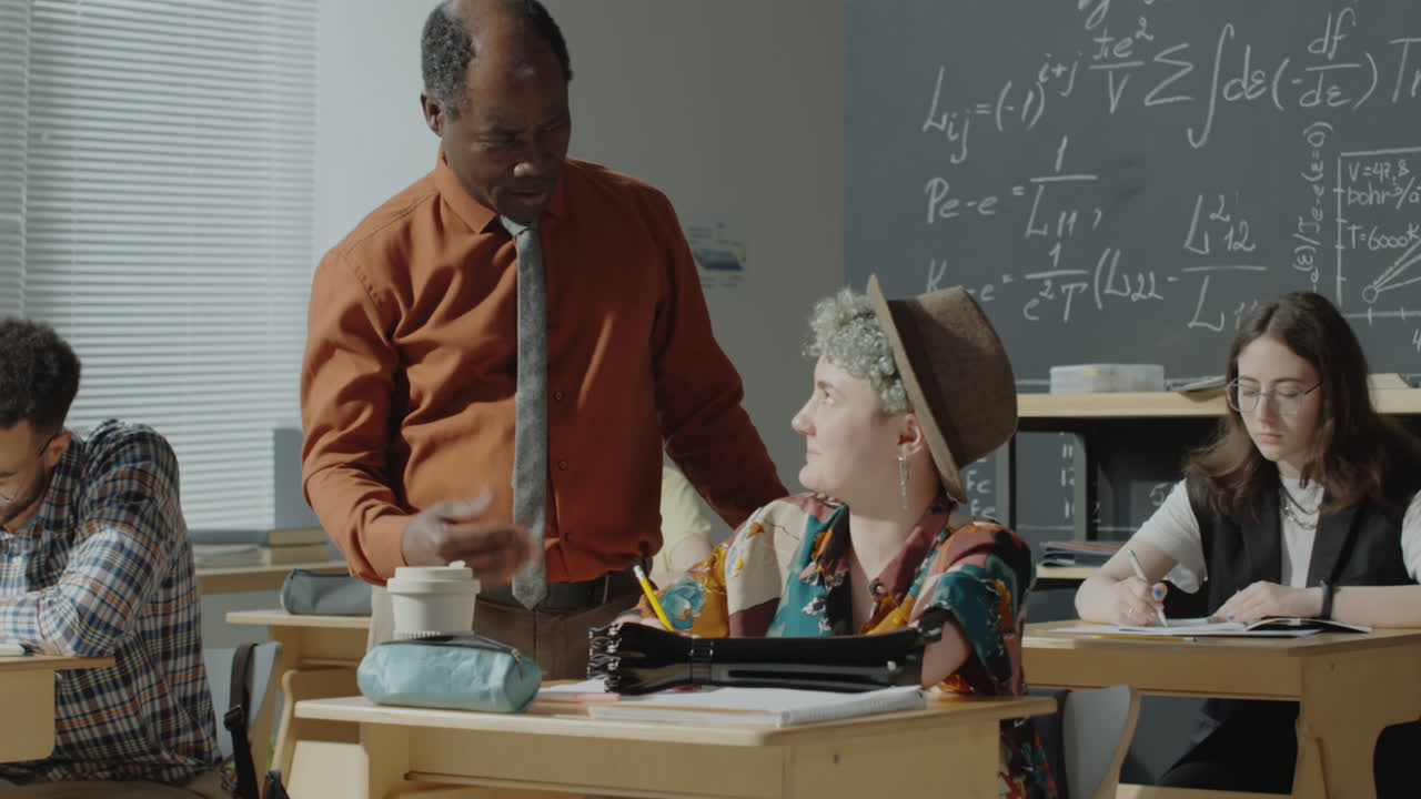 Teacher Assisting Students in a Classroom Setting