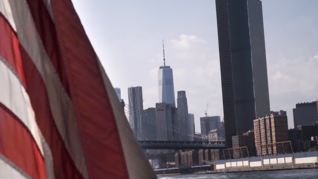 Waving American Flag on the Boat with a view from East River of Manhattan downtow- Financial District- One world trade center