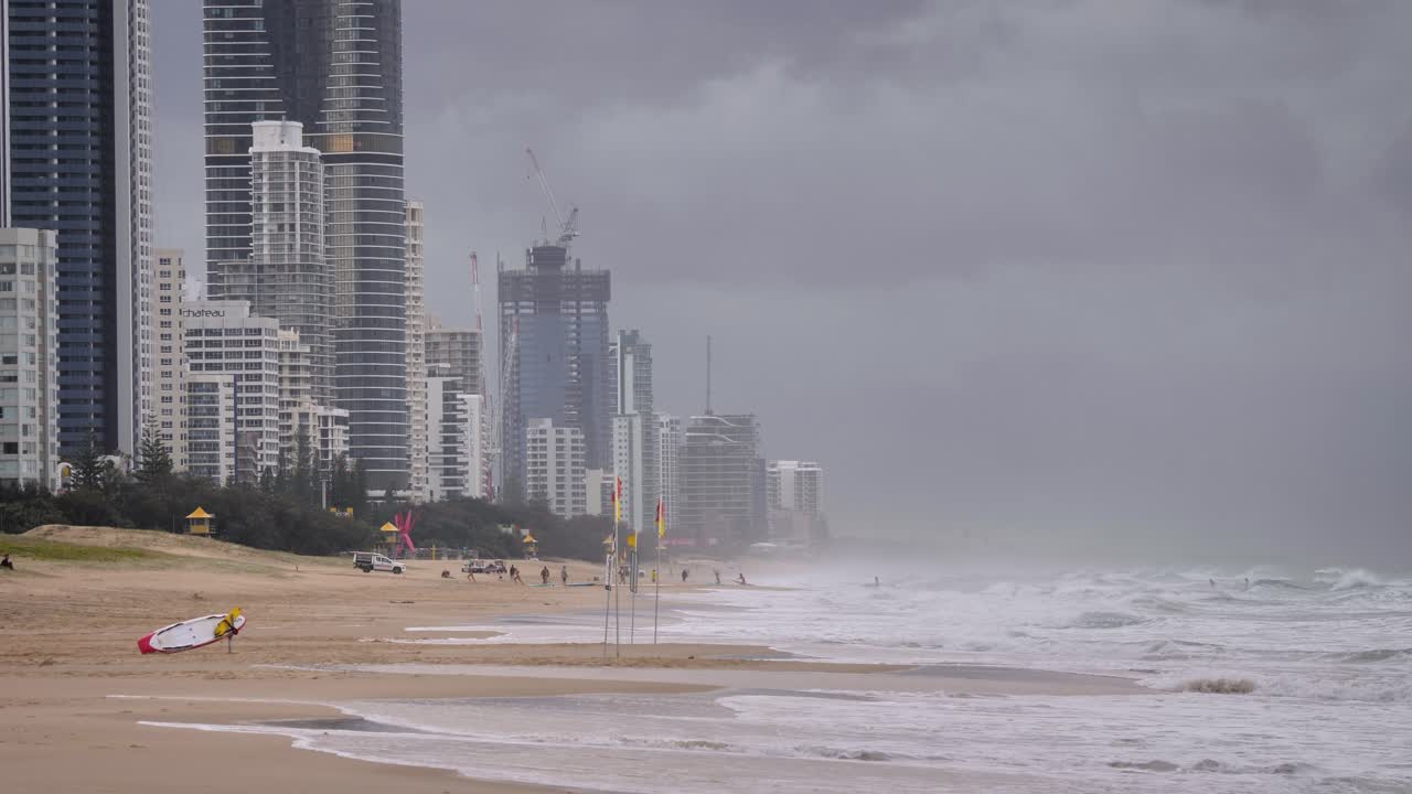 Tight shot of heavy storms over beaches on the Gold Coast causing rough seas and rain, Queensland, Australia.