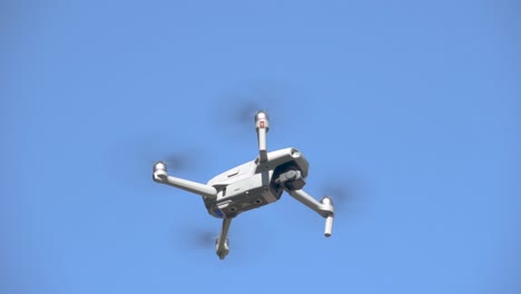 drone equipped with camera flying under blue sky in background