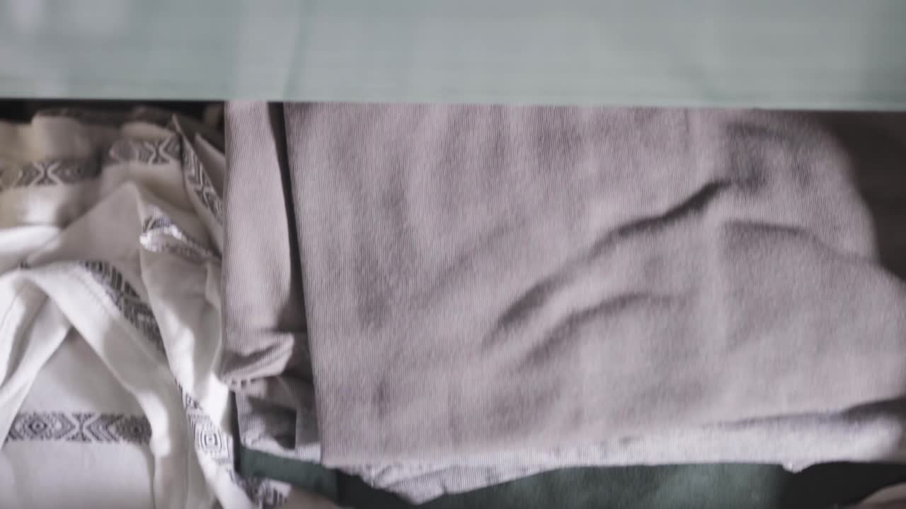 서랍에서 셔츠를 꺼내 닫습니다