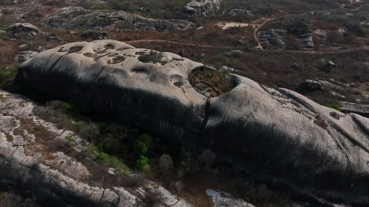 Massive rocky hill with circular depressions, aerial view from Chaval, Ceara