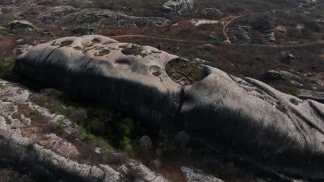massive rocky hill with circular depressions, aerial view from chaval, ceara