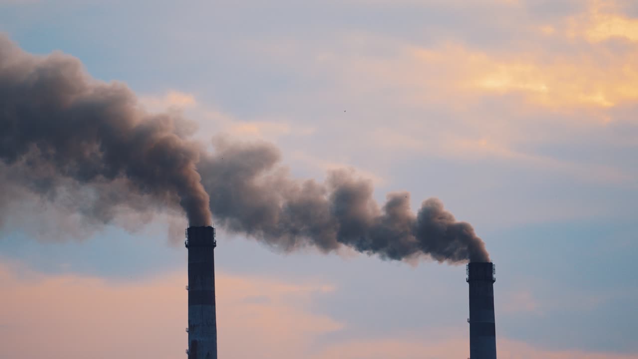 Air pollution in smoke from pipes of metallurgy plant. Massive air pollution filling the sky creating a toxic environment affecting life. Ecological disaster.