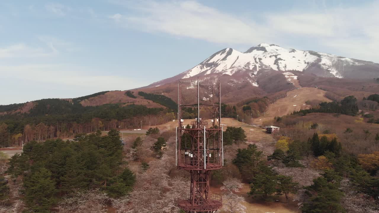 Aerial Drone Over radio tower of Mount Iwaki Japan with rural countryside landscape