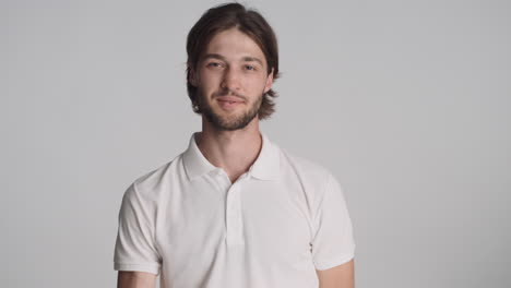 caucasian man in front of camera on gray background.