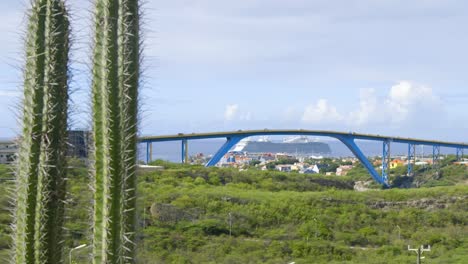 queen juliana bridge in the city of willemstad with a cruise ship docked behind in curacao, caribbean