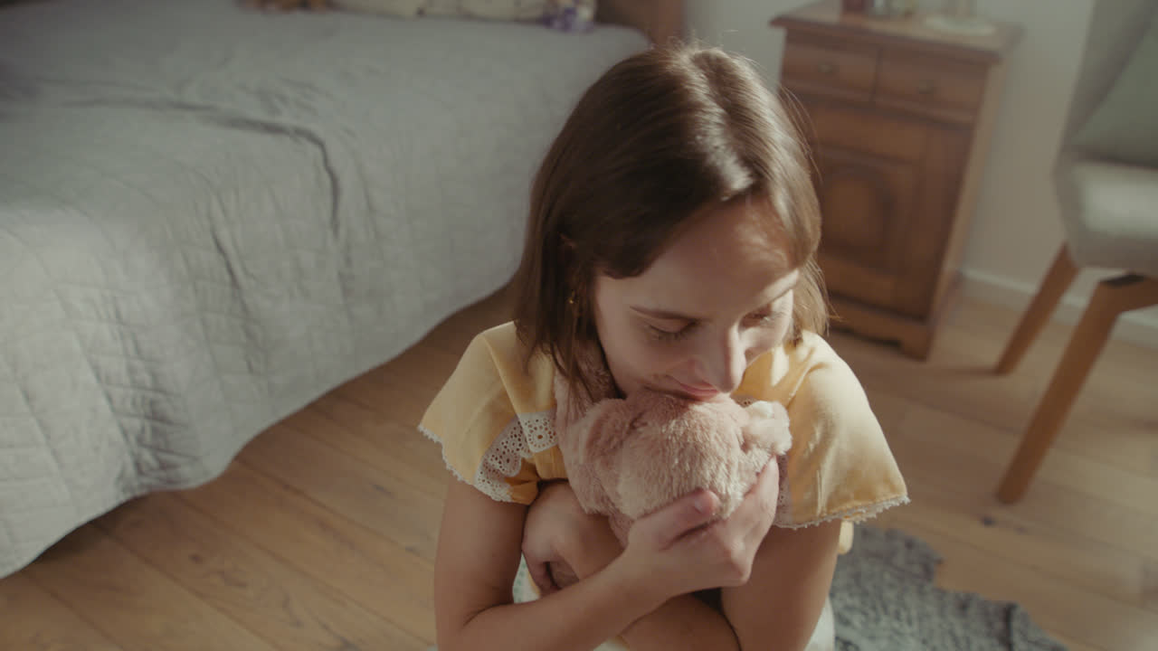 A girl playing with dolls in her room