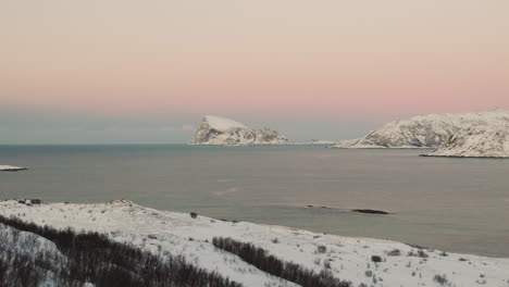 Distant-View-Of-Snowy-Mountain-On-Haaja-Island-As-Seen-From-Kvaloya-In-Tromso,-Norway