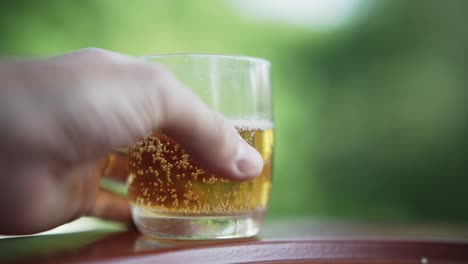 man take the glass of beer with blurred background