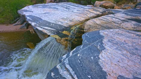 Morning-panning-shot-over-Sabino-Creek's-golden-waters-and-waterfall-with-ducks-in-Sabino-Canyon