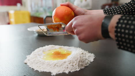 grate orange zest into easter cake dough