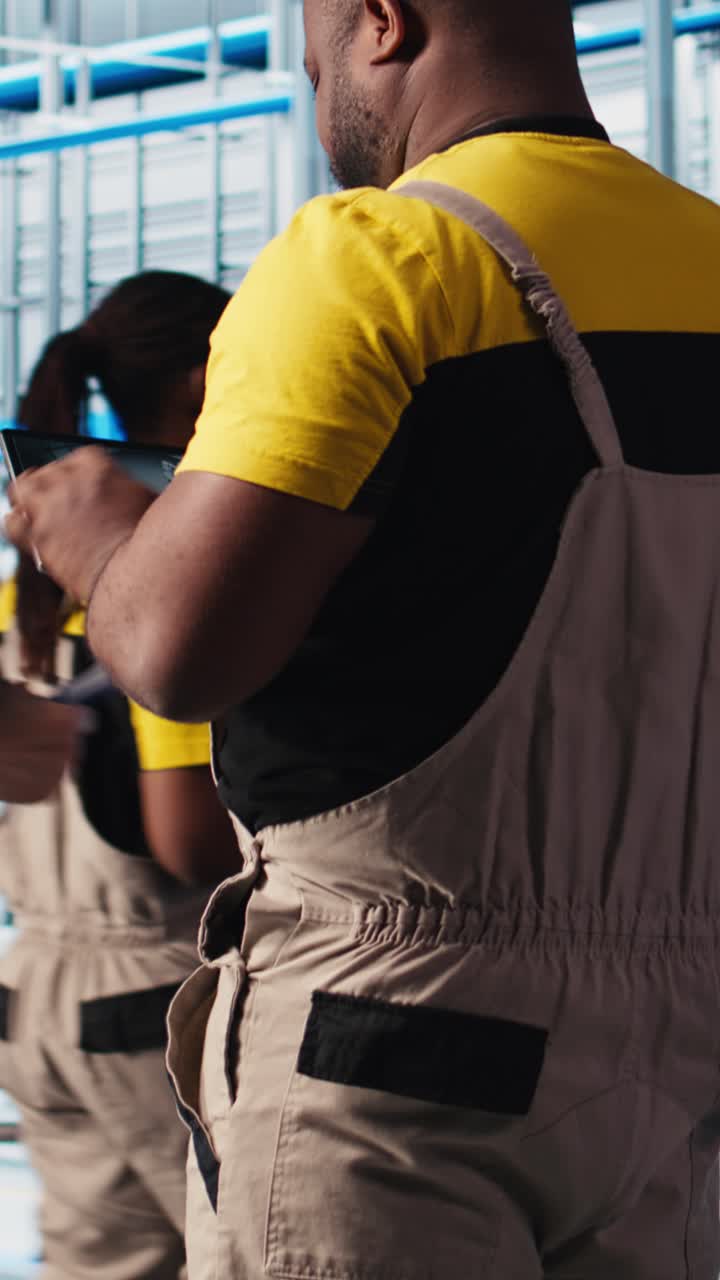 Vertical video Photovoltaic smart factory engineer uses CAD program on tablet