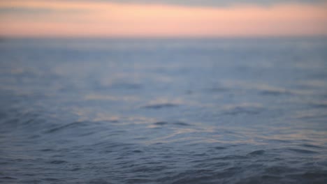 Small-Waves-Rolling-By-The-Sea-At-Sunset---Low-Level-Shot