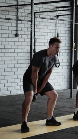 men working out with kettlebells