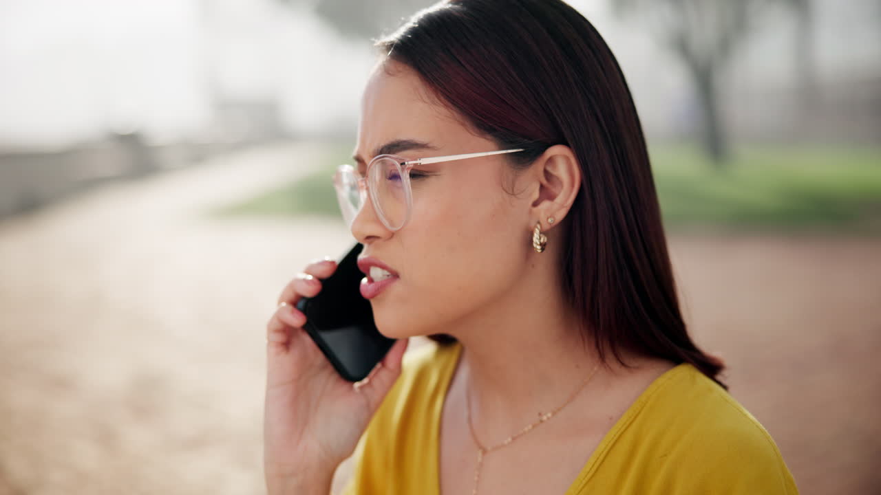 Woman talking on her phone in a park