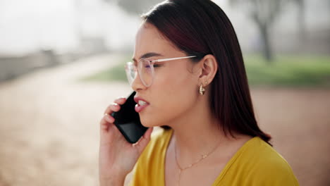 woman talking on her phone in a park