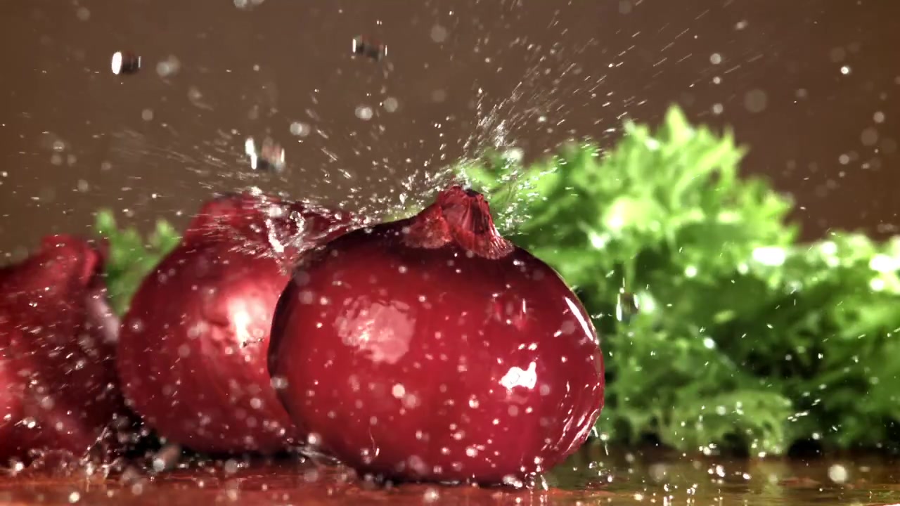 Slow Motion Water Splashing on Fresh Red Onions
