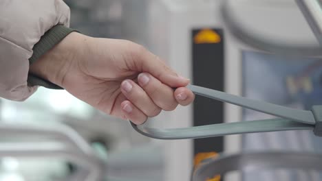 a person holding a hand strap on public transport