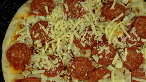 Top-down-view-of-a-spinning-pizza-on-a-tray