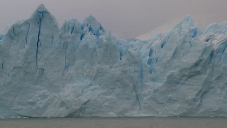 POV-from-a-boat-traveling-along-the-edge-of-a-glacier