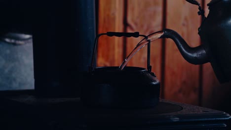 pouring water on an iron kettle. close-up shot