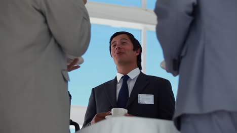 low angle view of a businessman holding coffee cup