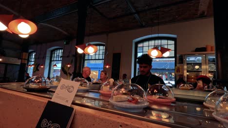 chef prepares desserts in a bustling restaurant