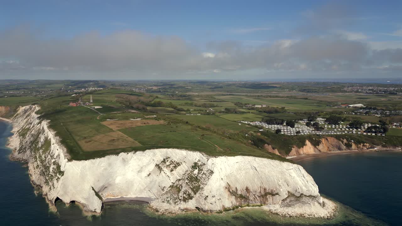 Drone glides over dramatic white cliffs and farmland on Isle of Wight coast