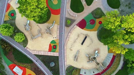 aerial top down shot above a modern, newly landscaped park and playground