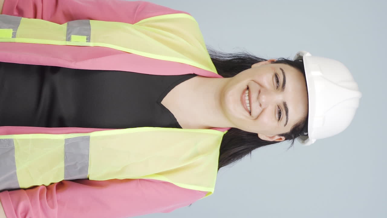 vídeo vertical del ingeniero con un casco de seguridad y sonriendo.